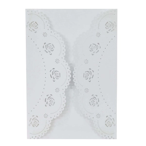 Detail of laser-cut rose floral patterns on elegant white wedding invitation card