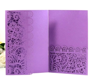Detail of laser-cut purple lace wedding invitation with pearl shimmer finish