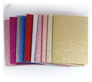 Macro view of assorted glitter cardstock sheets showing sparkling texture and vibrant colors