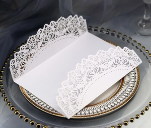 Elegant laser cut white wedding invitation with floral patterns on luxury ceramic plate
