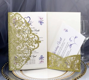 Detail of glitter laser cut gold invitation set with elegant floral wedding card