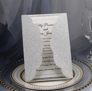 Detail of laser-cut silver glitter wedding invitation with elegant white inner card