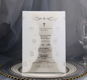 Close-up of laser-cut rose hollow invitation with elegant cream insert and gold-rimmed tray