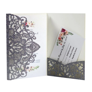 Detail of laser-cut glitter purple wedding invitation with intricate mandala lace and RSVP card