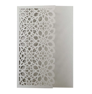 Macro shot of silver pearlescent laser-cut pocket wedding invitation card details