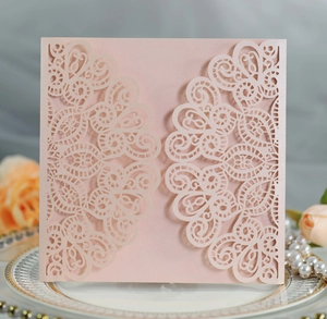 Detail of laser-cut light pink lace invitation shell with premium pearlescent paper texture