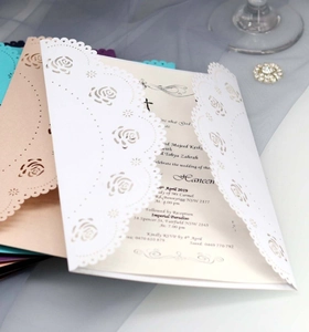 Detail of laser-cut rose hollow wedding invitations with elegant inner pages