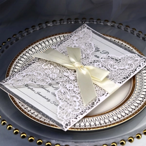 Elegant laser-cut wedding invitation with lace pattern, silver glitter and satin ribbon