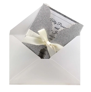 Silver laser cut wedding invitation with glitter finish and elegant white silk bow