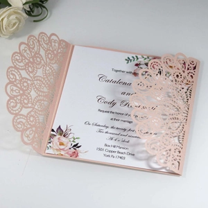 Pink laser-cut wedding invitation featuring elegant floral patterns and white inner card