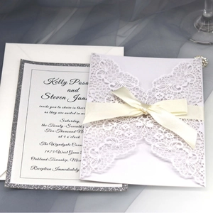 Elegant laser cut butterfly wedding invitation set with white ribbon and glitter border
