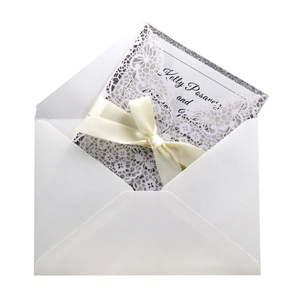 Laser cut wedding invitation set with light pink ribbon and white floral hollow shell