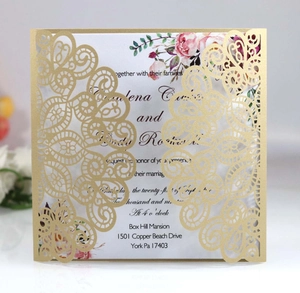 Detail of laser cut gold peacock lace wedding invitation with floral insert card