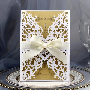 Elegant laser-cut heart wedding invitation with gold insert card and cream ribbon bow