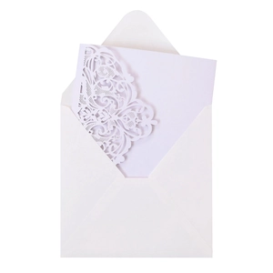 Detail of white laser-cut floral wedding invitation with elegant hollow pattern