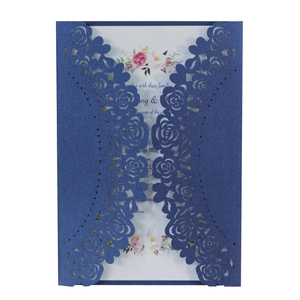 Detailed macro view of laser-cut rose hollow wedding invitation with navy pearlescent cover