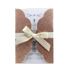 Detail of rose gold glitter laser-cut invitation with cross card and ribbon bow