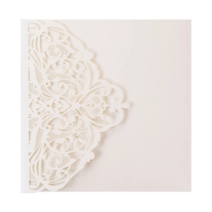 Detail of laser-cut lace pattern on ivory pearlescent paper wedding invitation