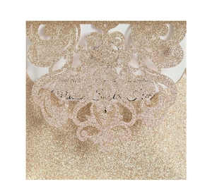Elegant laser cut wedding invitation with gold glitter floral patterns and intricate details
