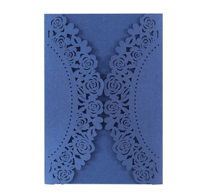Detail of laser-cut rose floral pattern on dark blue pearlescent paper invitation card