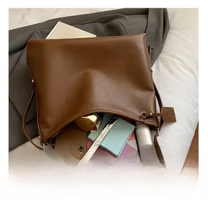 Interior view of brown leather tote bag showing space for iPad, phone and cosmetics