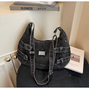 Detail of dark wash denim hobo bag with metal buckles and vintage Y2K stitching style