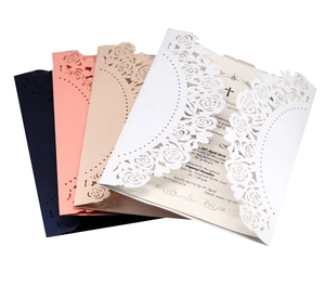 Macro view of laser-cut rose patterns on elegant wedding invitations in four colors