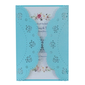 Detailed laser-cut rose patterns on elegant light blue pearlescent wedding invitation card