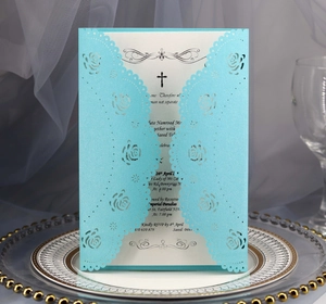 Macro detail of laser-cut rose floral invitation shell in Tiffany blue with white insert