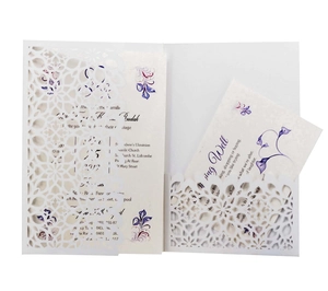Detail view of laser-cut floral invitation set with printed inserts on white background