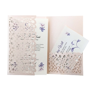 Macro detail of laser-cut wedding invitation featuring pink pearlescent floral pattern