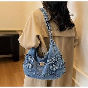 Detail view of large capacity vintage blue denim tote bag with metal brand plaque