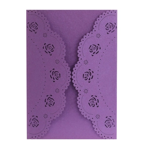 Close-up of laser-cut rose patterns on elegant purple pearlescent paper invitation cover