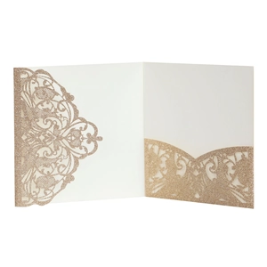 Detail of champagne gold laser-cut invitation holder with glitter finish and scrolls
