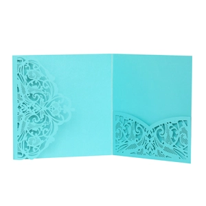Detailed laser cut lake blue invitation cover with intricate vine patterns and inner card slot