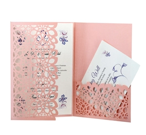 Elegant pink laser-cut wedding invitation set with floral inserts and wishing well card