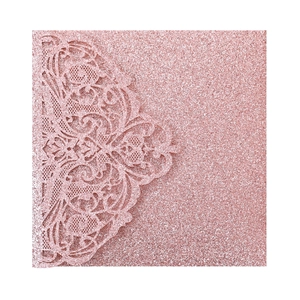 Detail of pink glitter laser-cut invitation sleeve with intricate lace hollow pattern