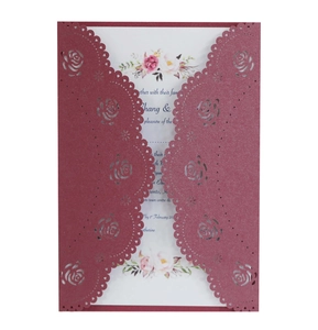 Detail of laser-cut burgundy rose wedding invitation with elegant floral inner card