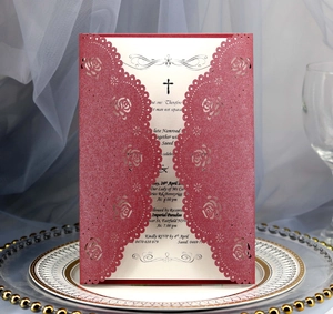 Macro detail of laser-cut rose hollow invitation card on an elegant white ceramic plate