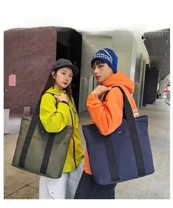 Detailed view of large capacity nylon tote bags in olive green and dark blue colors
