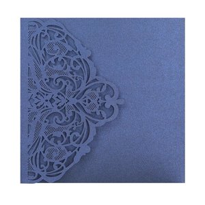 Detail of laser-cut floral patterns on deep blue pearlescent paper invitation card