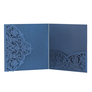 Macro view of laser-cut lace pattern and inner pocket on dark blue pearlized invitation