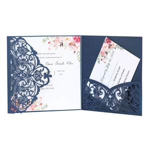Detailed laser-cut floral pattern on navy blue pearlescent wedding invitation suite