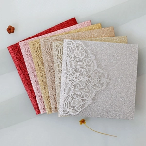 Detailed close-up of colorful laser-cut wedding invitations with glitter finish