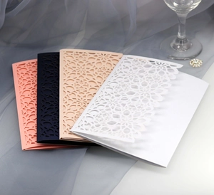 Detailed laser cut floral invitation pockets in navy blue, pink and champagne pearl paper