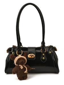 Chic black large capacity shoulder bag with gold hardware and brown bear charm accessory