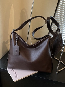 Minimalist large capacity dark brown leather crossbody tote bag with tassel detail