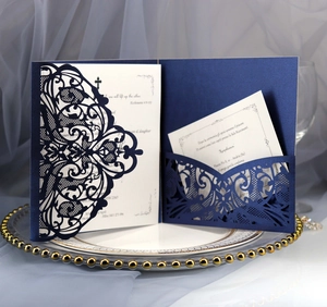 Macro shot of laser-cut navy blue wedding invitation with intricate lace hollow patterns