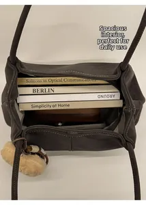 Top view of spacious suede tote bag showing large interior capacity for books and phone