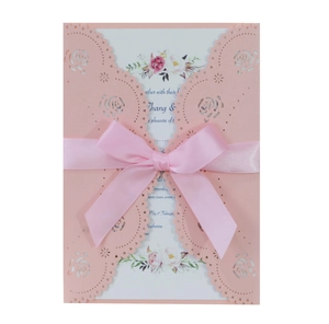 Pink laser-cut rose invitation card with a silk ribbon bow and floral inner page